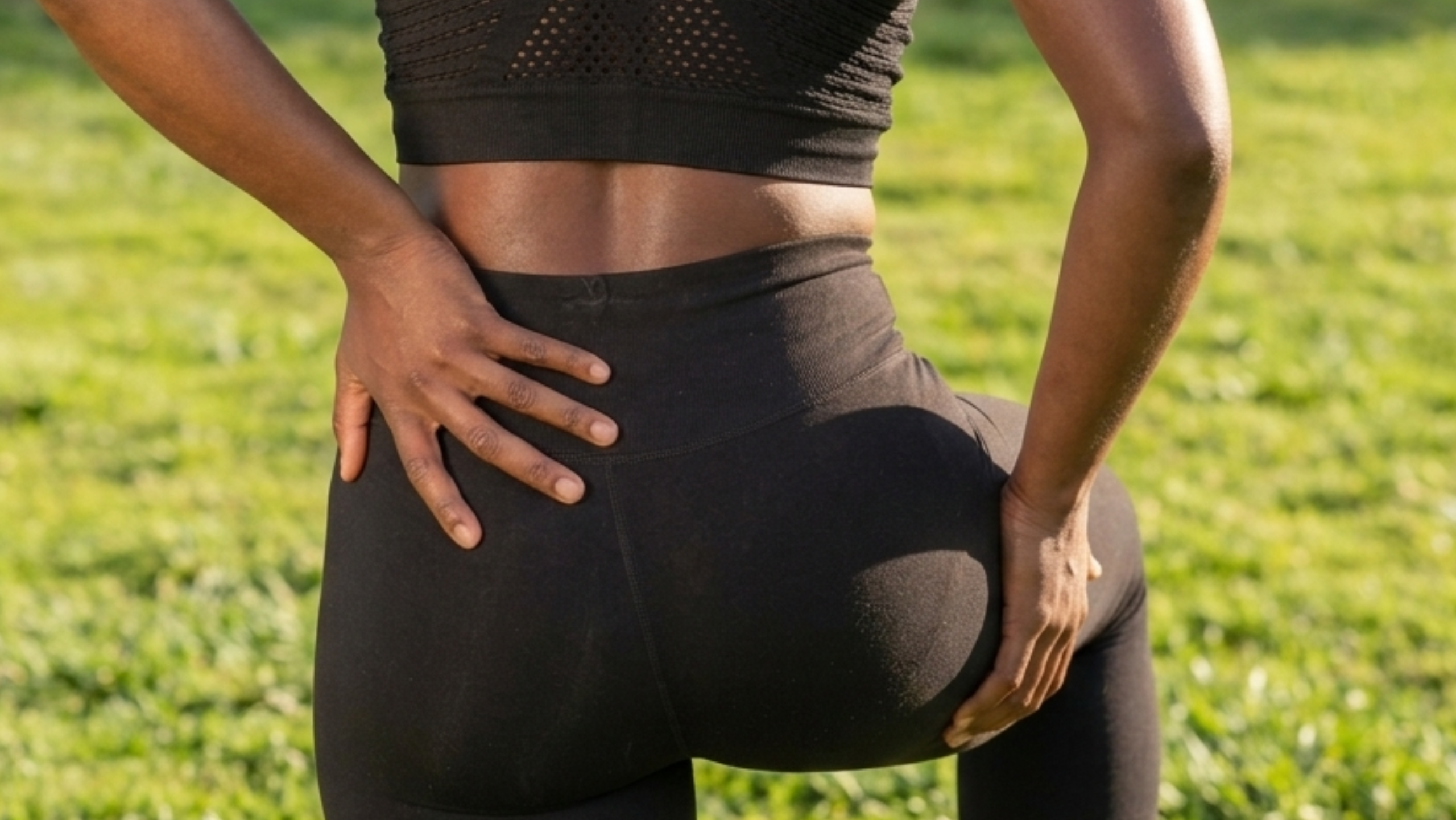 Person holding back of leg and hip showing sciatica pain symptoms treated by a chiropractor in Power Ranch Clinic chiropractor in Queen Creek AZ