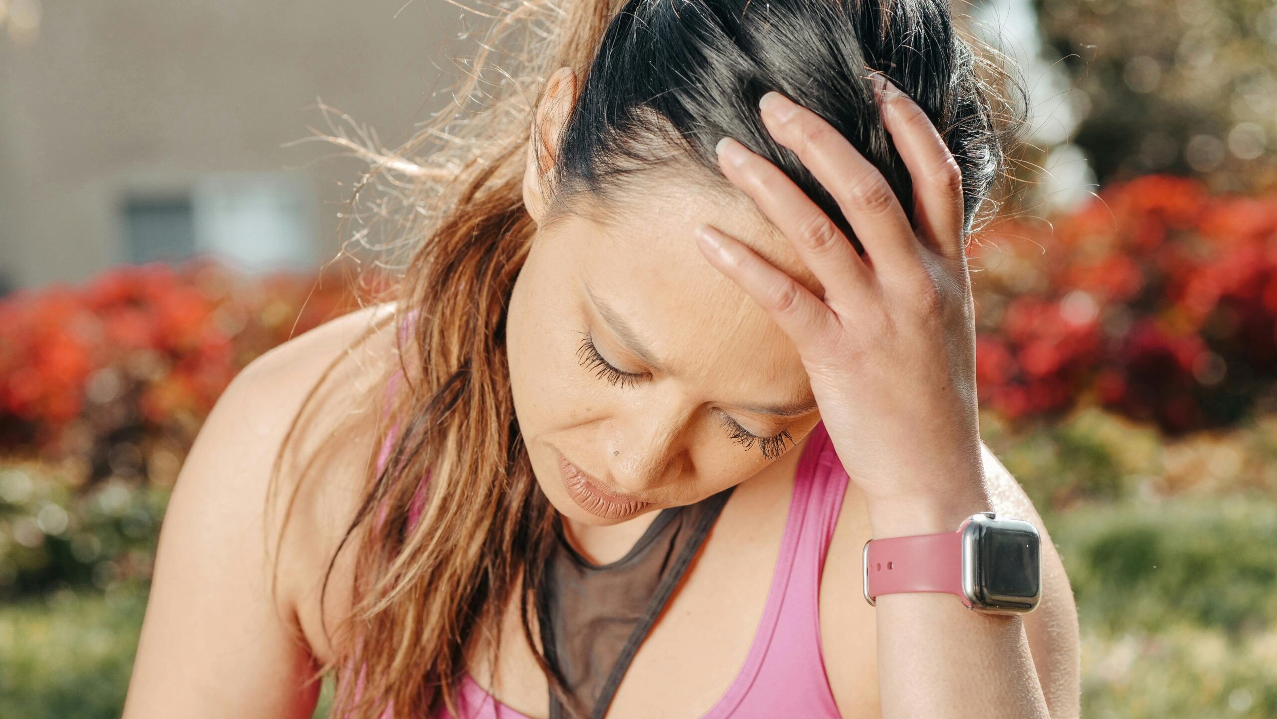 Woman holding head with tension headache pain symptoms seeking chiropractic care in Queen Creek, AZ near Power Ranch Area