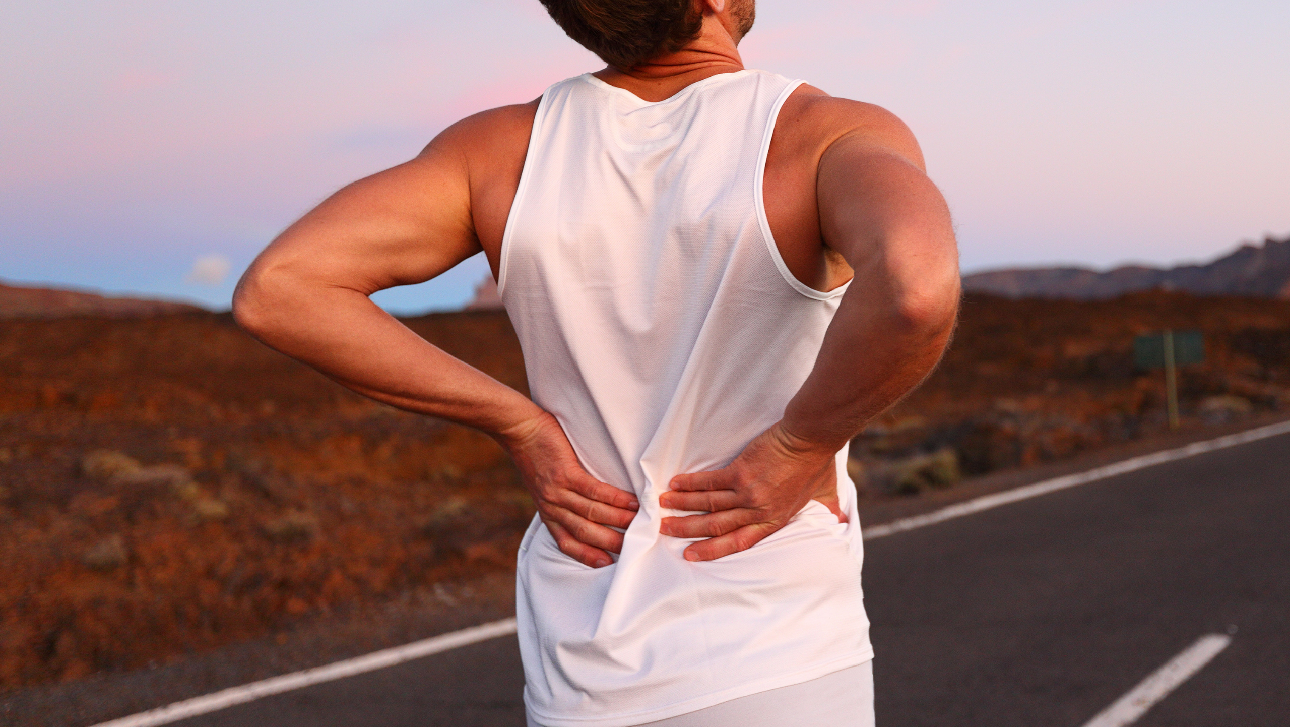 active man with low back pain seeking chiropractor in Gilbert AZ near San Tan Village