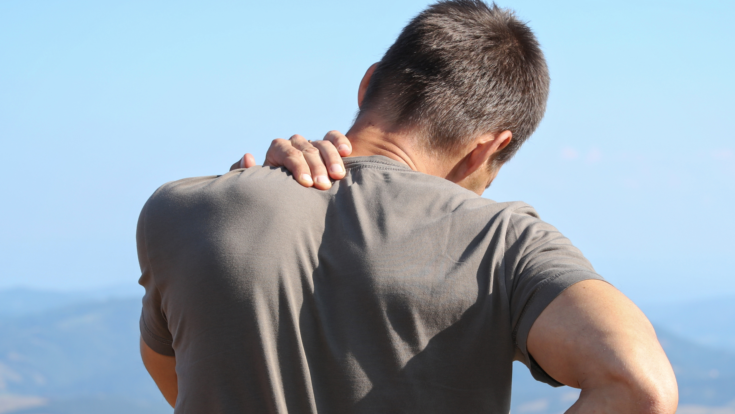 man seeking chiropractor for mid back pain relief Gilbert AZ in San Tan Village