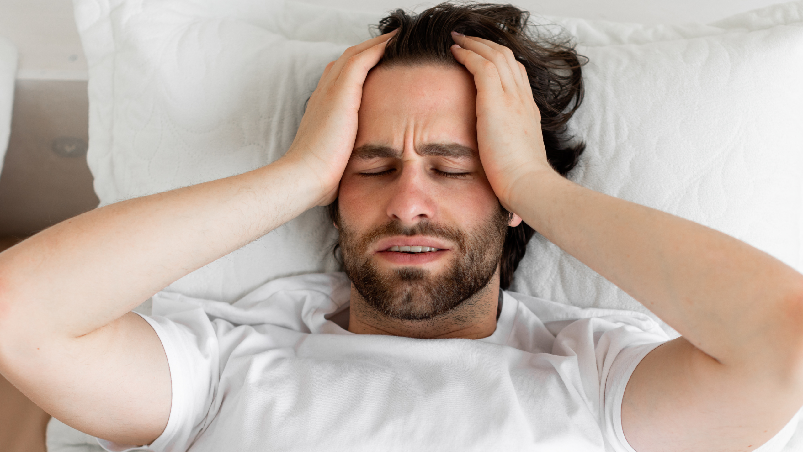 man with headache looking for chiropractor Gilbert AZ near San Tan Village