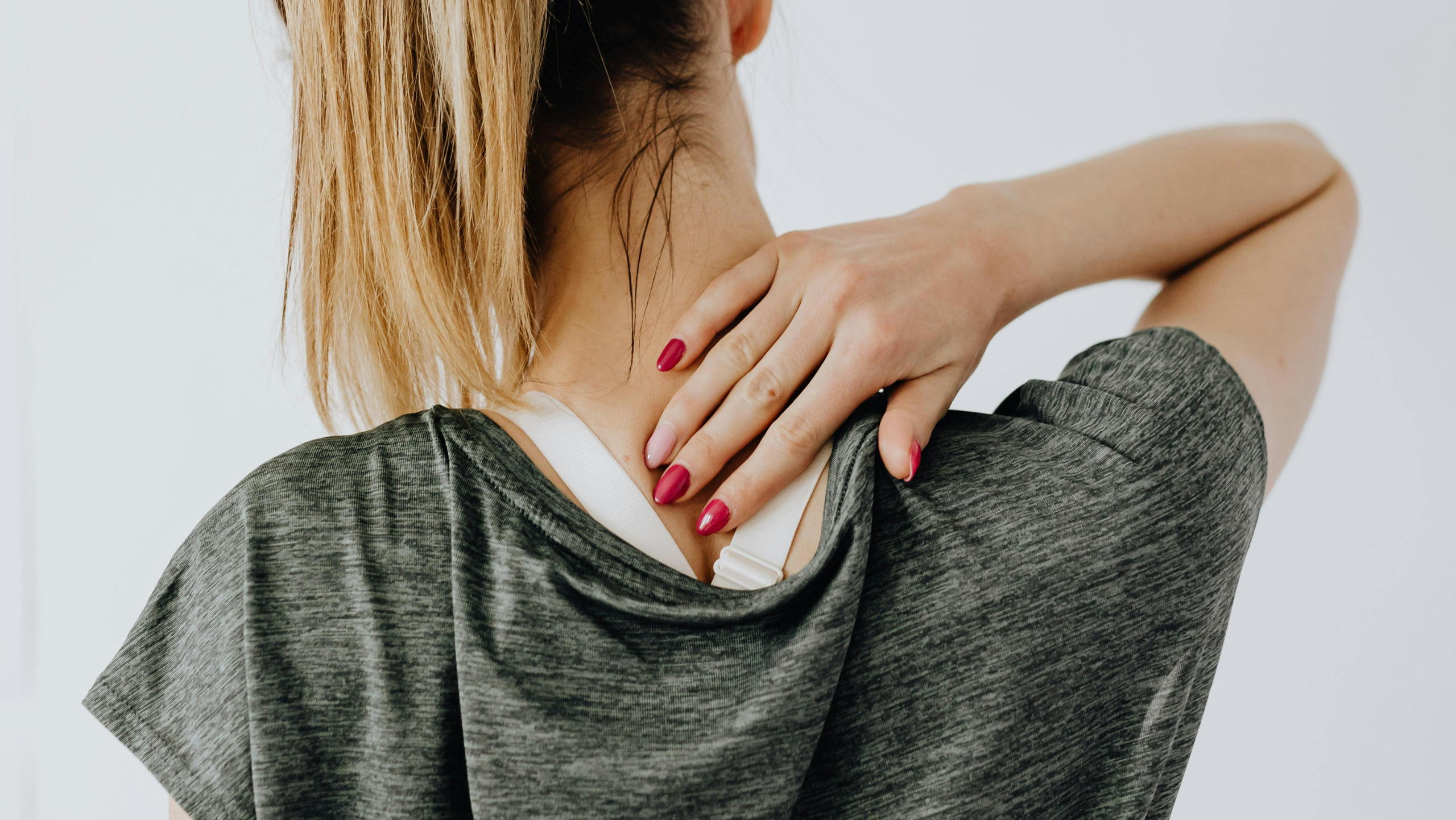 Woman seeking chiropractor for mid back pain relief in Queen Creek, AZ