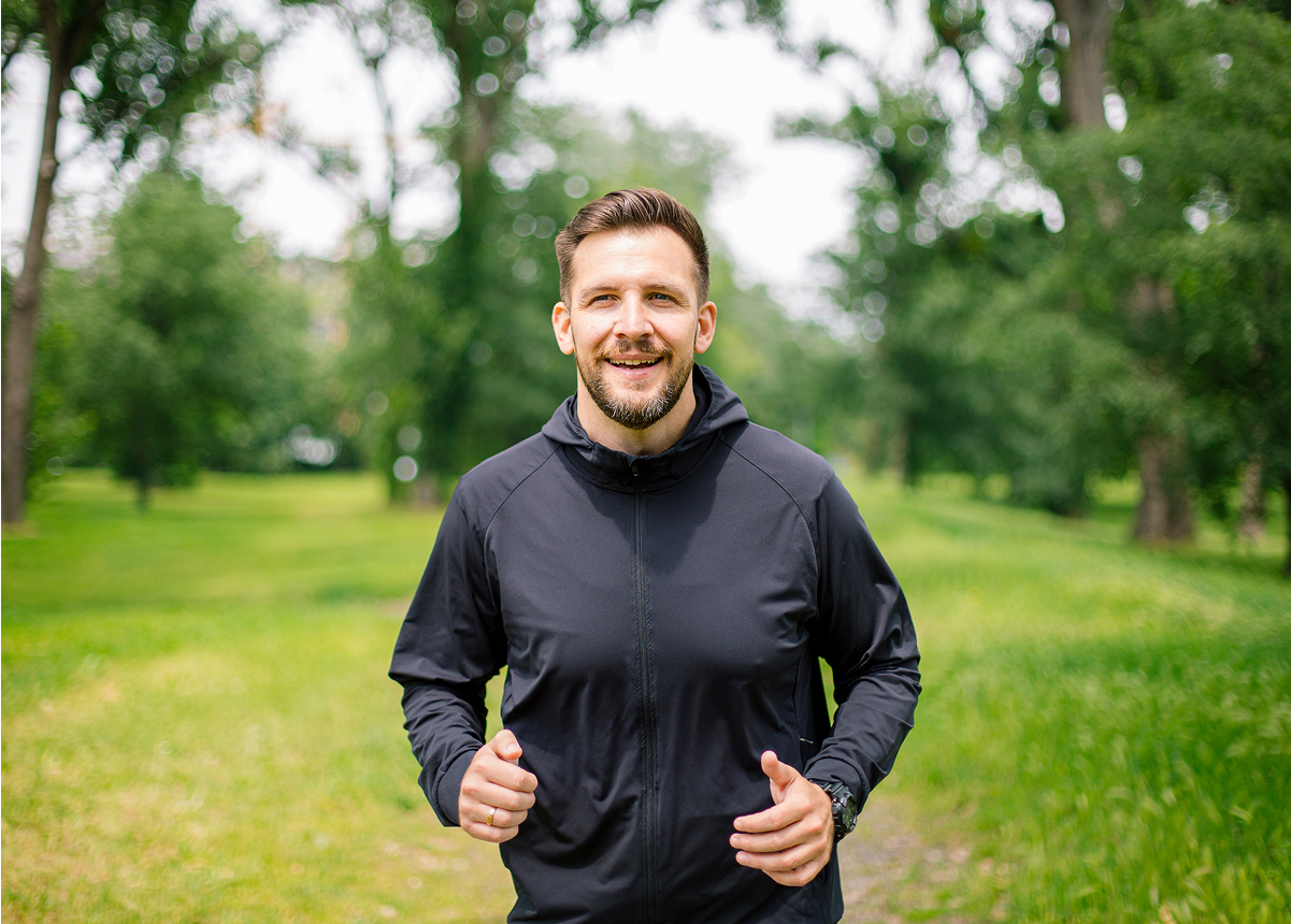 Man standing outdoors representing adults seeking relief from recurring low back pain in the Southeast Valley.