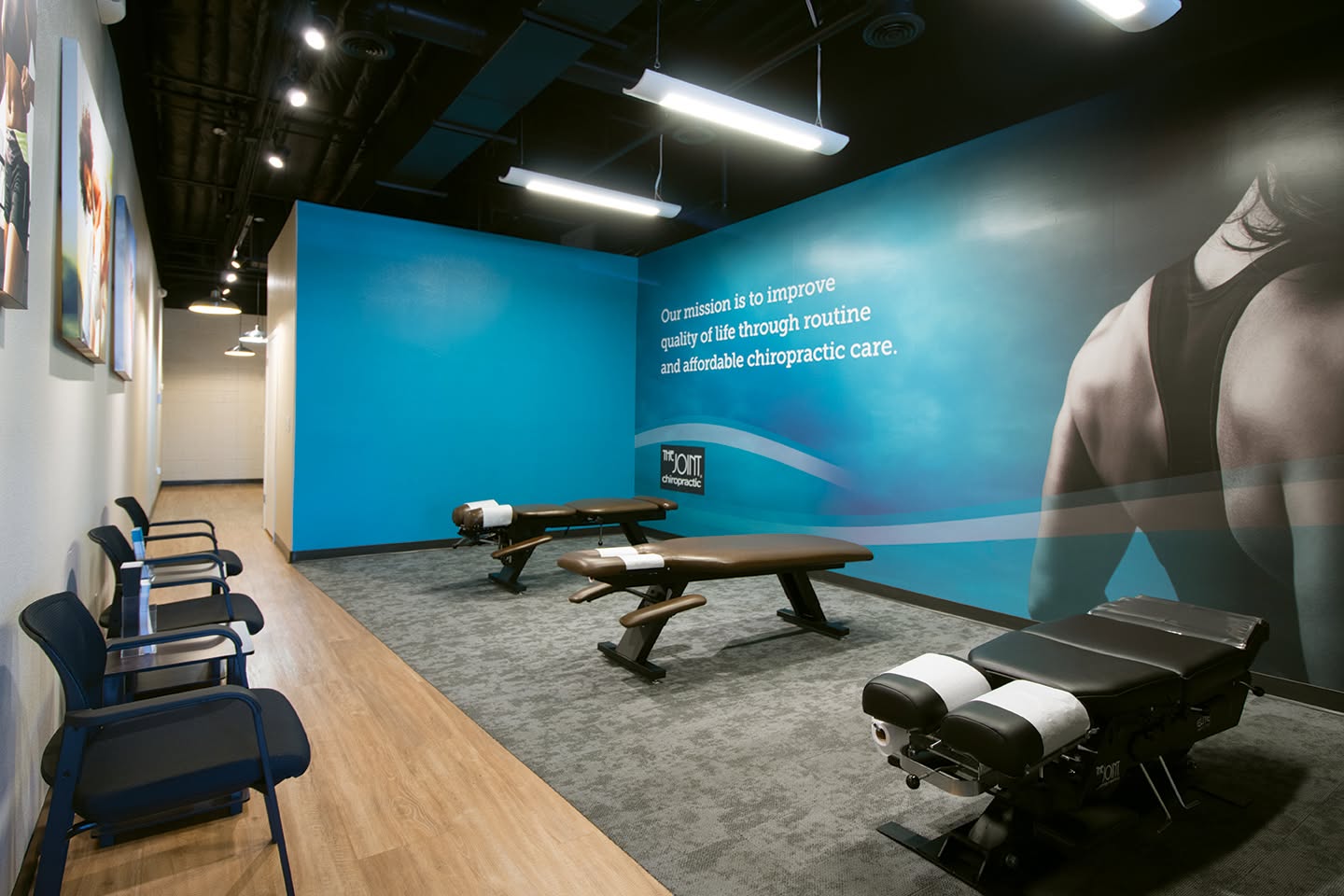 Interior of The Joint Chiropractic clinic in the Southeast Valley featuring chiropractic adjustment tables and a welcoming treatment area.