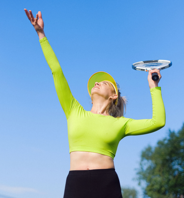 Woman playing tennis outdoors in the Southeast Valley